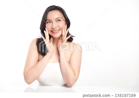 A beautiful young Asian woman with clean, fresh skin against a white background. Skincare, facial treatment, cosmetology, beauty, and spa. An elegant portrait of an Asian woman. A beautiful young Asian woman with clean, fresh skin against a white background. Skincare, facial treatment, cosmetology, beauty, and spa. An elegant portrait of an Asian woman. 138187189