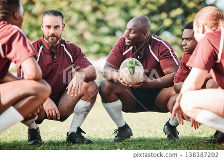 Sports, huddle and rugby team on a pitch planning a strategy for a game, match or tournament. Fitness, diversity and captain talking to group at training, exercise or practice on an outdoor field. Sports, huddle and rugby team on a pitch planning a strategy for a game, match or tournament. Fitness, diversity and captain talking to group at training, exercise or practice on an outdoor field. 138187202