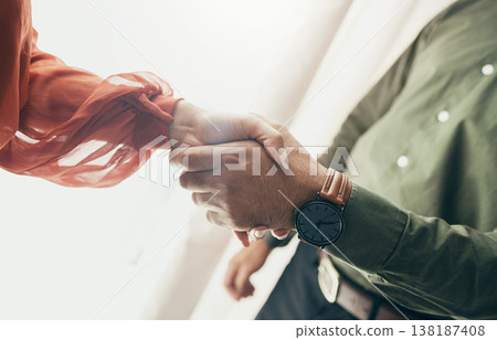 Business people, handshake and partnership in meeting, b2b deal or teamwork below at office. Low angle of man and woman shaking hands for startup, introduction or thank you in agreement at workplace 138187408