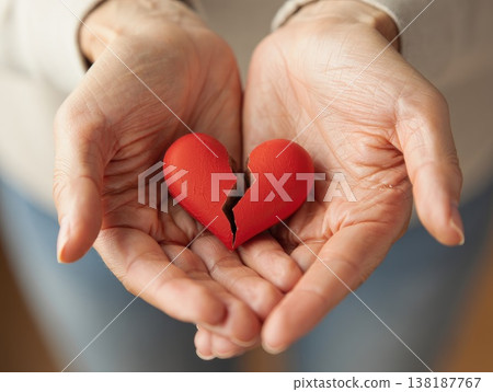 Broken heart in the hands - divorce concept. photo with red heart. 138187767