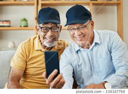 Video call, phone and senior men on sofa smile for chat, conversation and video call at home. Retirement, hello and mature people on smartphone for internet, discussion and bonding in living room Video call, phone and senior men on sofa smile for chat, conversation and video call at home. Retirement, hello and mature people on smartphone for internet, discussion and bonding in living room 138187768