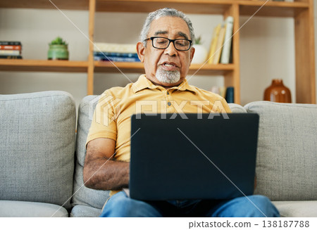 Typing, senior man and laptop on sofa in home with online research in living room or streaming video, movies or tv show. Elderly, person or writing on computer in retirement for blog or communication Typing, senior man and laptop on sofa in home with online research in living room or streaming video, movies or tv show. Elderly, person or writing on computer in retirement for blog or communication 138187788