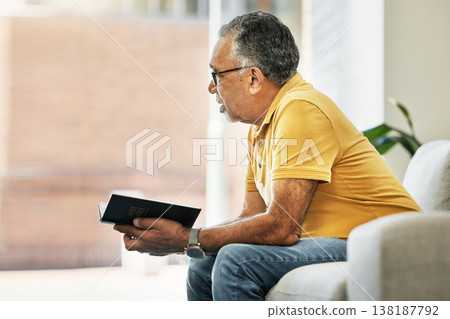 Senior man, thinking and reading a book on sofa in home living room learning knowledge, information or ideas. Elderly, person and relax in retirement with novel, books or inspiration for fiction 138187792