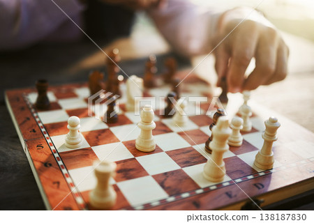 Hands, chess game and board with strategy in competition or challenge, intelligence and closeup of people playing. Thinking, planning and contest outdoor, concentration on boardgame and recreation Hands, chess game and board with strategy in competition or challenge, intelligence and closeup of people playing. Thinking, planning and contest outdoor, concentration on boardgame and recreation 138187830