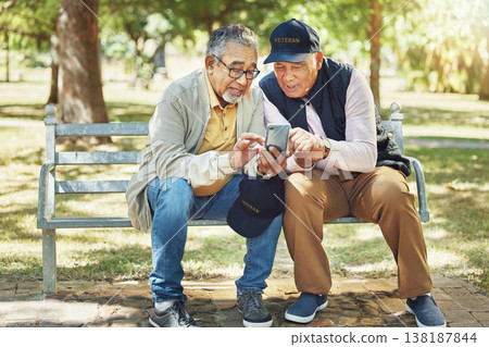 Friends, phone and senior men on a park bench with social media, map or text together. Smartphone, search and elderly people online in nature for map, navigation or location, app or direction guide 138187844