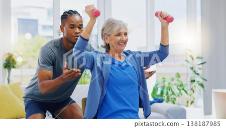 Rehabilitation, strong and woman with a physiotherapist for exercise, strength training and support. Help, fitness and a senior patient lifting dumbbells with black man in physiotherapy for recovery Rehabilitation, strong and woman with a physiotherapist for exercise, strength training and support. Help, fitness and a senior patient lifting dumbbells with black man in physiotherapy for recovery 138187985