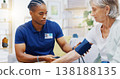Caregiver, black man or old woman with blood pressure test consulting in hospital to monitor heart wellness. Healthcare, hypertension consultation or medical nurse with sick patient for examination 138188135