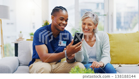 Phone, medical and a nurse talking to a patient in an assisted living facility for senior people. Healthcare, mobile and contact with a black man medicine professional chatting to a mature woman 138188144