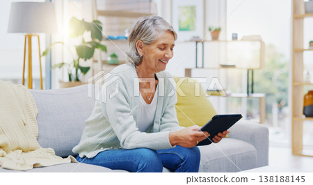 Relax, tablet and senior woman on sofa in living room scroll on social media, mobile app or the internet. Rest, online and elderly female person browsing on website with technology in lounge at home. 138188145