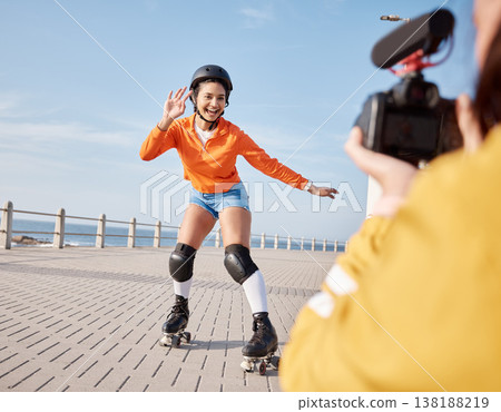 Girl, rollerskates and smile for camera, boardwalk and fun by ocean, sea and outdoors for hobby. Active person, skating and sport in summer, protection and gear for safety, energy and happy in summer Girl, rollerskates and smile for camera, boardwalk and fun by ocean, sea and outdoors for hobby. Active person, skating and sport in summer, protection and gear for safety, energy and happy in summer 138188219