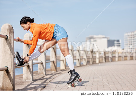 Woman, roller skates and outdoor in park, stretching legs and training for contest, fitness or health by ocean. Gen z girl, skating and walk for exercise, workout or metro road by sea in Cape Town 138188226