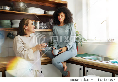 Coffee, smile and lesbian couple in home kitchen, bonding and communication. Drink tea, gay women and happy girls in the morning at breakfast together in interracial relationship, care and LGBT love 138188307