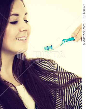 Woman holds toothbrush with paste. Woman holds toothbrush with paste. 138188323