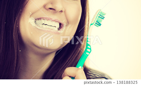 Woman brushing cleaning teeth. 138188325