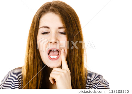Unhappy woman touching her cheek feeling pain 138188330