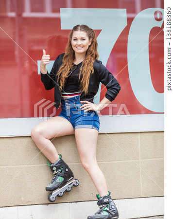 Woman wearing roller skates next to sale Woman wearing roller skates next to sale 138188360
