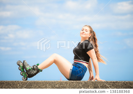 Happy young woman wearing roller skates 138188368