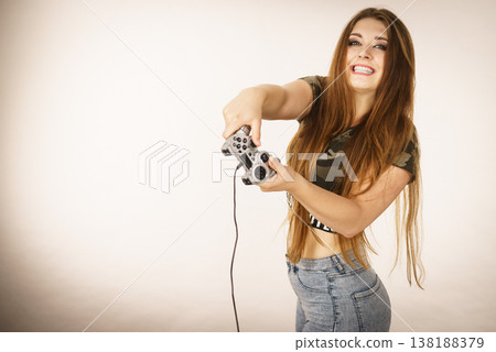 Gamer woman holding gaming pad Gamer woman holding gaming pad 138188379