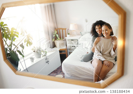 Lesbian, couple and women sitting on bed with hug, love and commitment for together in cozy home. LGBTQ, relax and partner with happiness in apartment, bonding and reflection in bedroom mirror Lesbian, couple and women sitting on bed with hug, love and commitment for together in cozy home. LGBTQ, relax and partner with happiness in apartment, bonding and reflection in bedroom mirror 138188434
