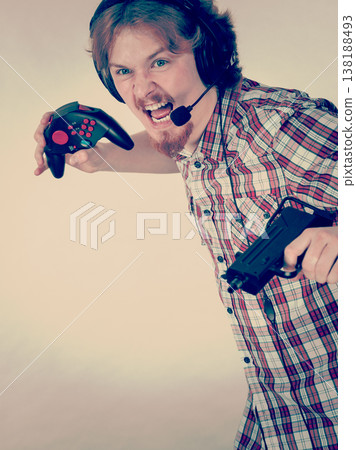 Gamer man shooting from gun Gamer man shooting from gun 138188493