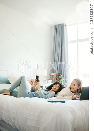 Technology, social media and morning with a lesbian couple in bed together in their home on the weekend. Relax, diversity and an lgbt woman with her girlfriend in the bedroom for love or bonding Technology, social media and morning with a lesbian couple in bed together in their home on the weekend. Relax, diversity and an lgbt woman with her girlfriend in the bedroom for love or bonding 138188507