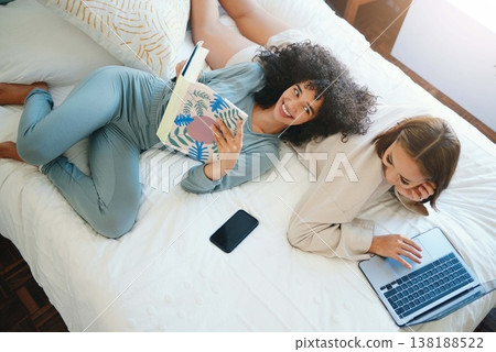 Laptop, morning and a lesbian couple relax in bed while together in their home on the weekend. Reading, computer and book with happy lgbt woman with her girlfriend in the bedroom from above for love Laptop, morning and a lesbian couple relax in bed while together in their home on the weekend. Reading, computer and book with happy lgbt woman with her girlfriend in the bedroom from above for love 138188522