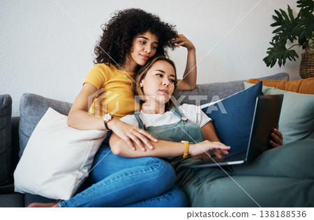 Lgbtq, laptop and women relax on sofa for watching movies, streaming series and online videos. Dating, lesbian and happy couple on computer for internet, bonding and relationship in living room 138188536