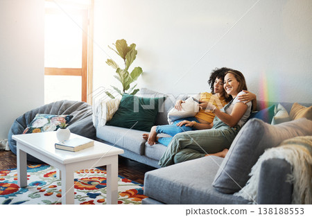 Love, relax and a lesbian couple watching tv on a sofa in the living room of their home together. Smile, LGBT and a woman with her girlfriend enjoying a movie on a subscription streaming service Love, relax and a lesbian couple watching tv on a sofa in the living room of their home together. Smile, LGBT and a woman with her girlfriend enjoying a movie on a subscription streaming service 138188553