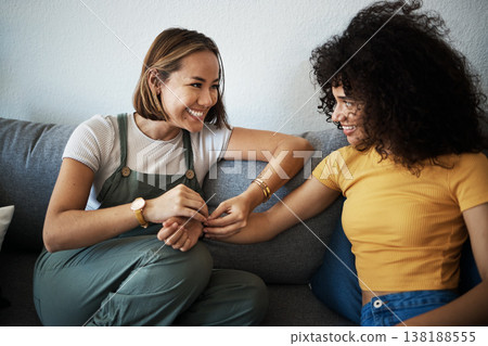 Conversation, happy and lesbian couple relaxing on a sofa in the living room talking and bonding. Love, communication and young interracial lgbtq women speaking and resting together in lounge at home 138188555
