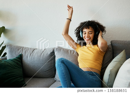 Headphones, music and woman dance on a sofa with podcast, album or audio track at home. Radio, earphones and female person having fun in living room with feel good subscription, streaming or freedom Headphones, music and woman dance on a sofa with podcast, album or audio track at home. Radio, earphones and female person having fun in living room with feel good subscription, streaming or freedom 138188631