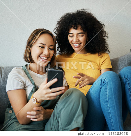 Friends, relax on sofa with smartphone and chat online with communication, funny meme and reading text message. Women with technology, mobile app and typing on social media with connectivity at home Friends, relax on sofa with smartphone and chat online with communication, funny meme and reading text message. Women with technology, mobile app and typing on social media with connectivity at home 138188658
