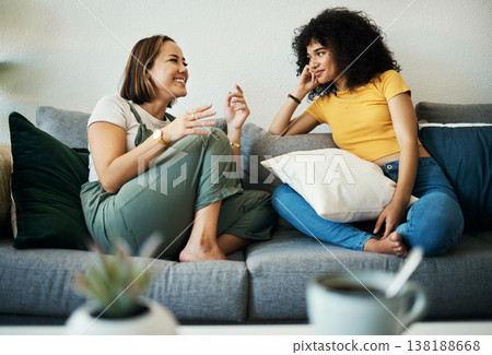 Women, friends relax and conversation in a home with gossip, discussion and happy in a living room. Couch, smile and female person on sofa with communication together in a house lounge with speaking Women, friends relax and conversation in a home with gossip, discussion and happy in a living room. Couch, smile and female person on sofa with communication together in a house lounge with speaking 138188668