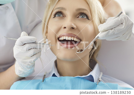 Close up shot of young woman keeping mouth widely opened, going to cure teeth in dentistry clinic Close up shot of young woman keeping mouth widely opened, going to cure teeth in dentistry clinic 138189230