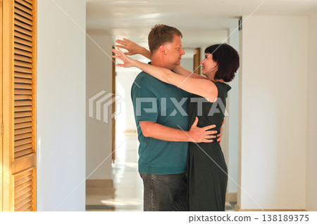Romantic embrace of a loving adult couple in a hotel corridor, capturing the essence of intimacy and connection in a cozy, elegant setting Romantic embrace of a loving adult couple in a hotel corridor, capturing the essence of intimacy and connection in a cozy, elegant setting 138189375