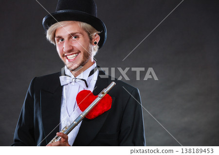 Male flutist with flute and heart. Love melody 138189453