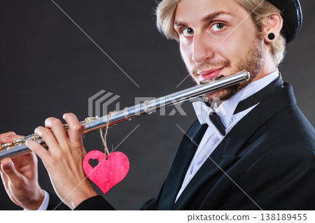 Male flutist with flute and heart. Love melody 138189455