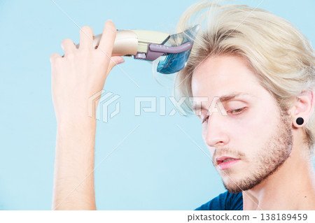 Man going to shave his long hair 138189459