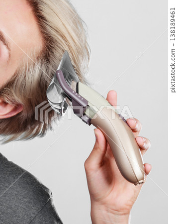 Man going to shave his long hair 138189461