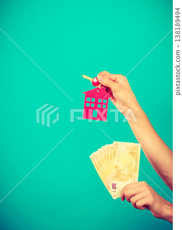 Person holding money and keys to house Person holding money and keys to house 138189494