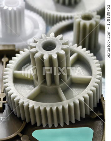 Various plastic gears on a workbench at a manufacturing site showing different sizes and shapes during production process 138189752