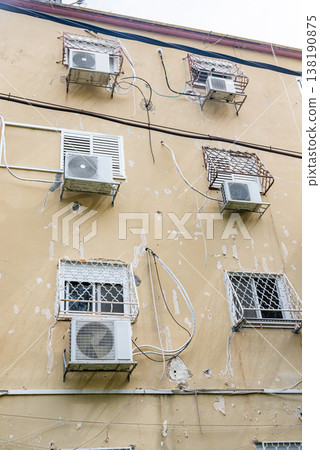 Multiple outdoor air conditioning units installed on exterior wall of residential building. Urban cooling systems and climate control concept. Multiple outdoor air conditioning units installed on exterior wall of residential building. Urban cooling systems and climate control concept. 138190875