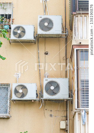 Multiple outdoor air conditioning units installed on exterior wall of residential building. Urban cooling systems and climate control concept. 138190876