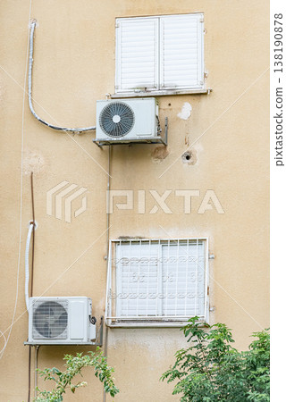 Multiple outdoor air conditioning units installed on exterior wall of residential building. Urban cooling systems and climate control concept. 138190878