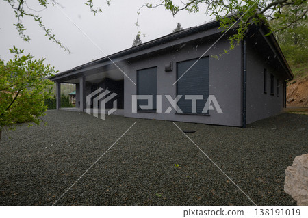 Modular modern smart automated house in winter with closed shutters and gravel yard, unfinished insulation work Modular modern smart automated house in winter with closed shutters and gravel yard, unfinished insulation work 138191019