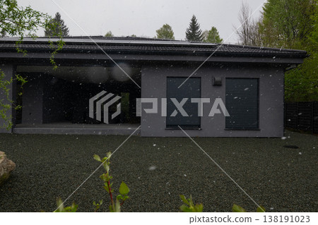 Modular modern smart automated house exterior in snow with solar panels and unfinished work in progress 138191023