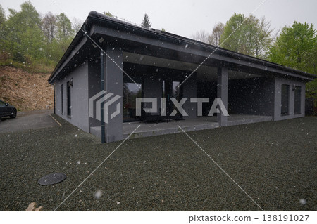 Modular modern smart house in winter snow with ongoing construction and insulated exterior 138191027