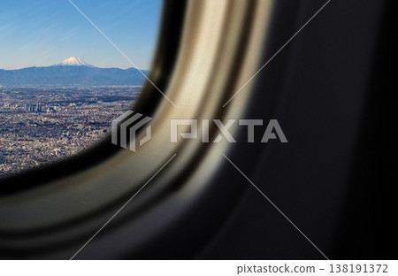 View of Mount Fuji and the city from the airplane window. View of Mount Fuji and the city from the airplane window. 138191372