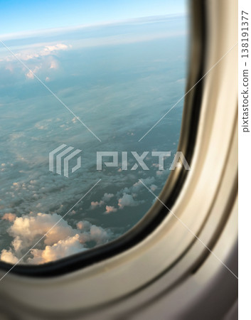 Blue sky and clouds visible from the airplane window Blue sky and clouds visible from the airplane window 138191377