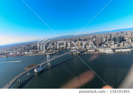 The Tokyo cityscape and Rainbow Bridge as seen from a helicopter. 138191403