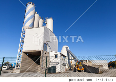 A concrete and cement plant featuring tall storage silos A concrete and cement plant featuring tall storage silos 138191784